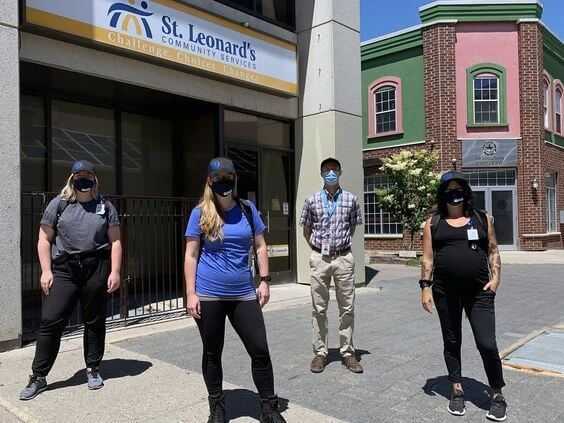 Brantford Downtown Outreach Team standing on the sidewalk with masks on.