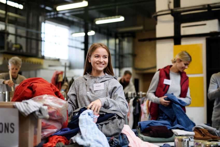 Young woman performing community service at a donation centre
