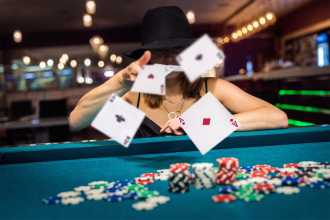 Woman at a casino table throwing down her cards