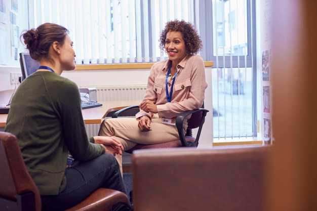 A woman talking to a counsellor.